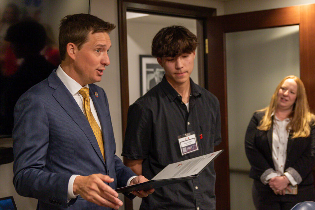 Lt. Gov. Matt Pinnell recognizes Magnus Miller with award.